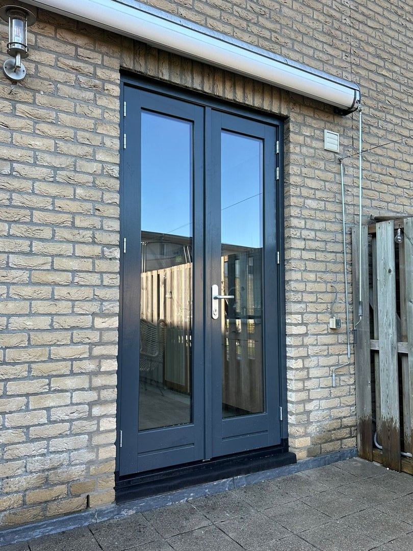 Stijlvolle deur met bijpassende kozijnen, vakkundig geïnstalleerd door Nervabouw en Kozijnen voor een moderne en veilige toegang tot de woning.